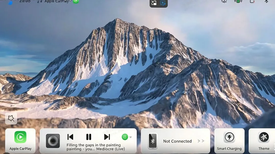Head-unit home screen with a mountain wallpaper and a bottom widget row: an Apple CarPlay tile, a media player showing a track, a Bluetooth tile reading Not Connected, Smart Charging and Theme.